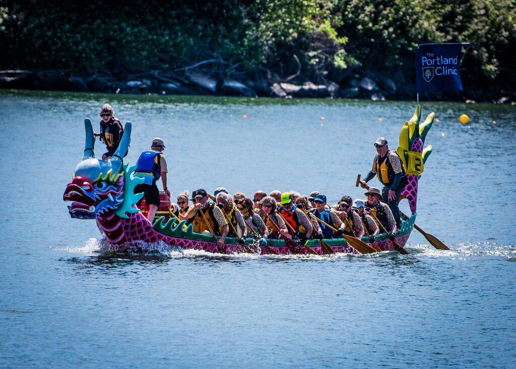 colorful dragon boat with 23 person crew, racing